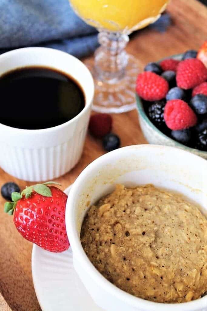 A mug muffin with coffee and berries.