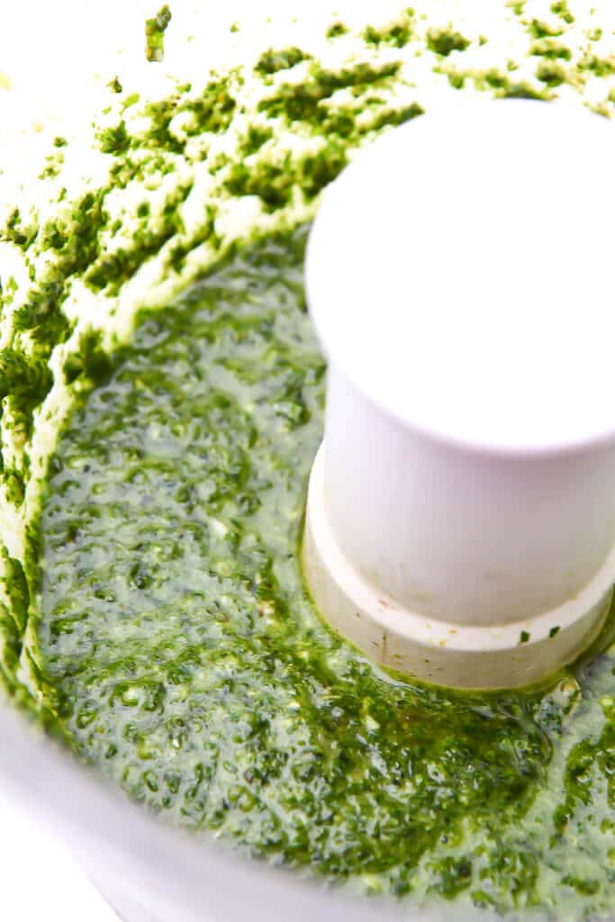 Vegan pesto blended up in a food processor.