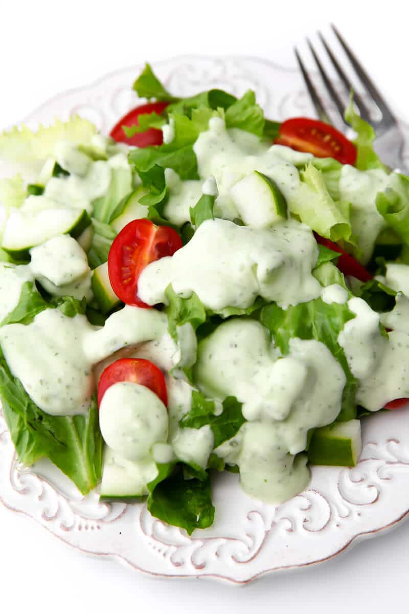 A top view of a salad with vegan ranch on it.