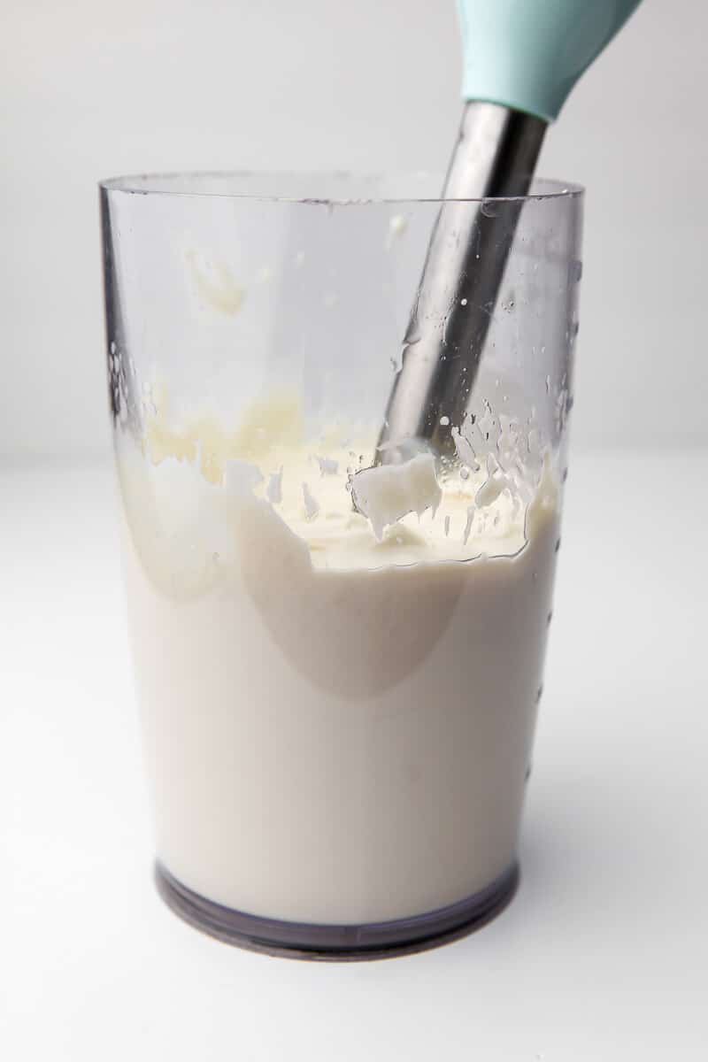 All the ingredients for tofu sour cream in a blending container after being blended with an immersion blender.