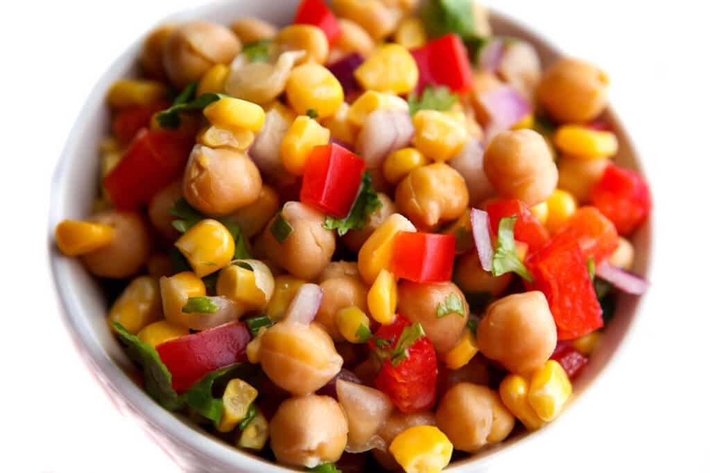 A top view of a colorful citrus salad with a white background. 