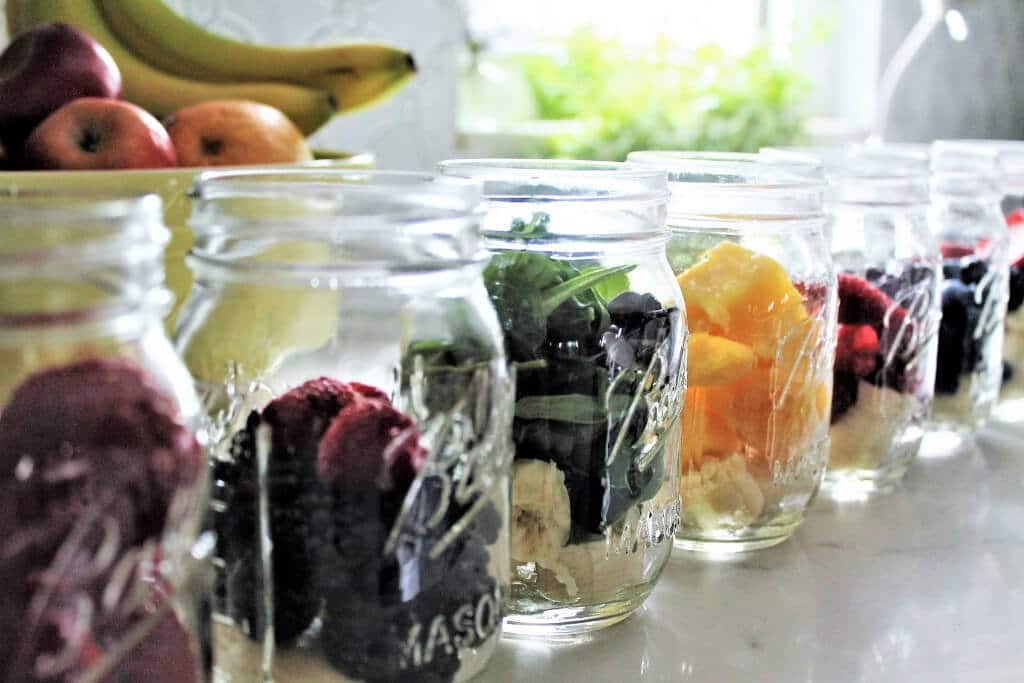 Jars lined up to assemble make ahead smoothies.