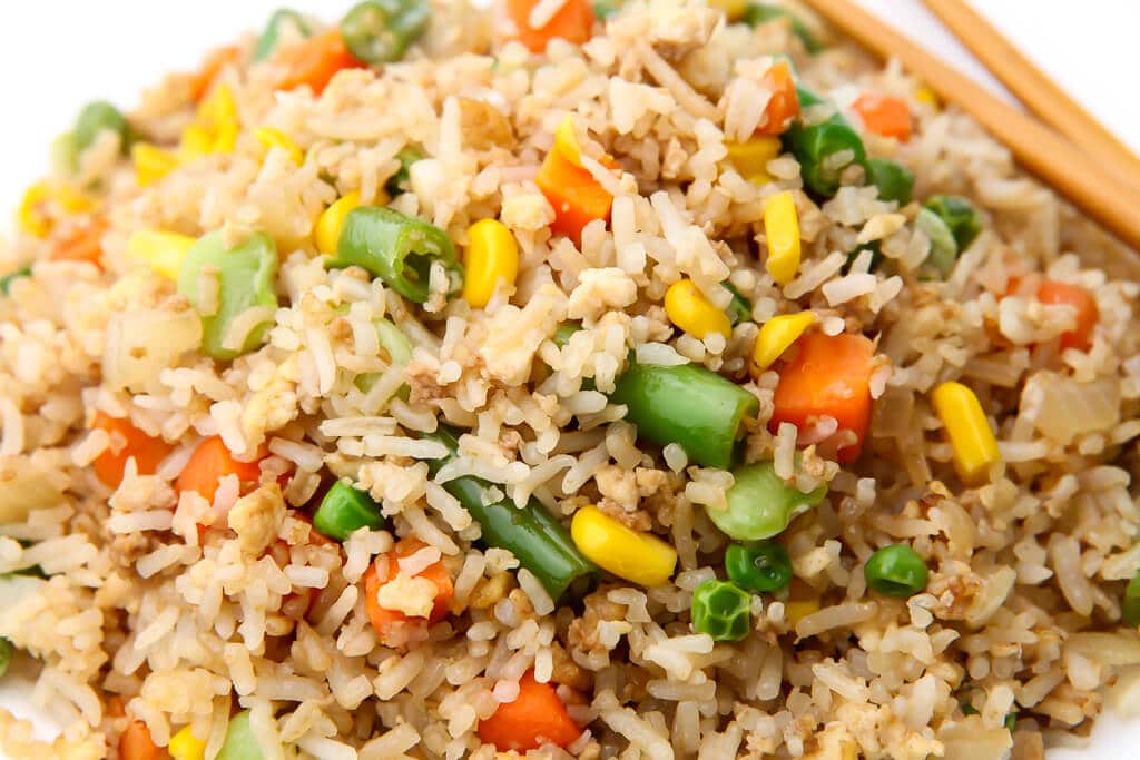A close up of a plate of veggie fried rice.