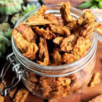 A glass jar filled with vegan jerky made with soy curls.