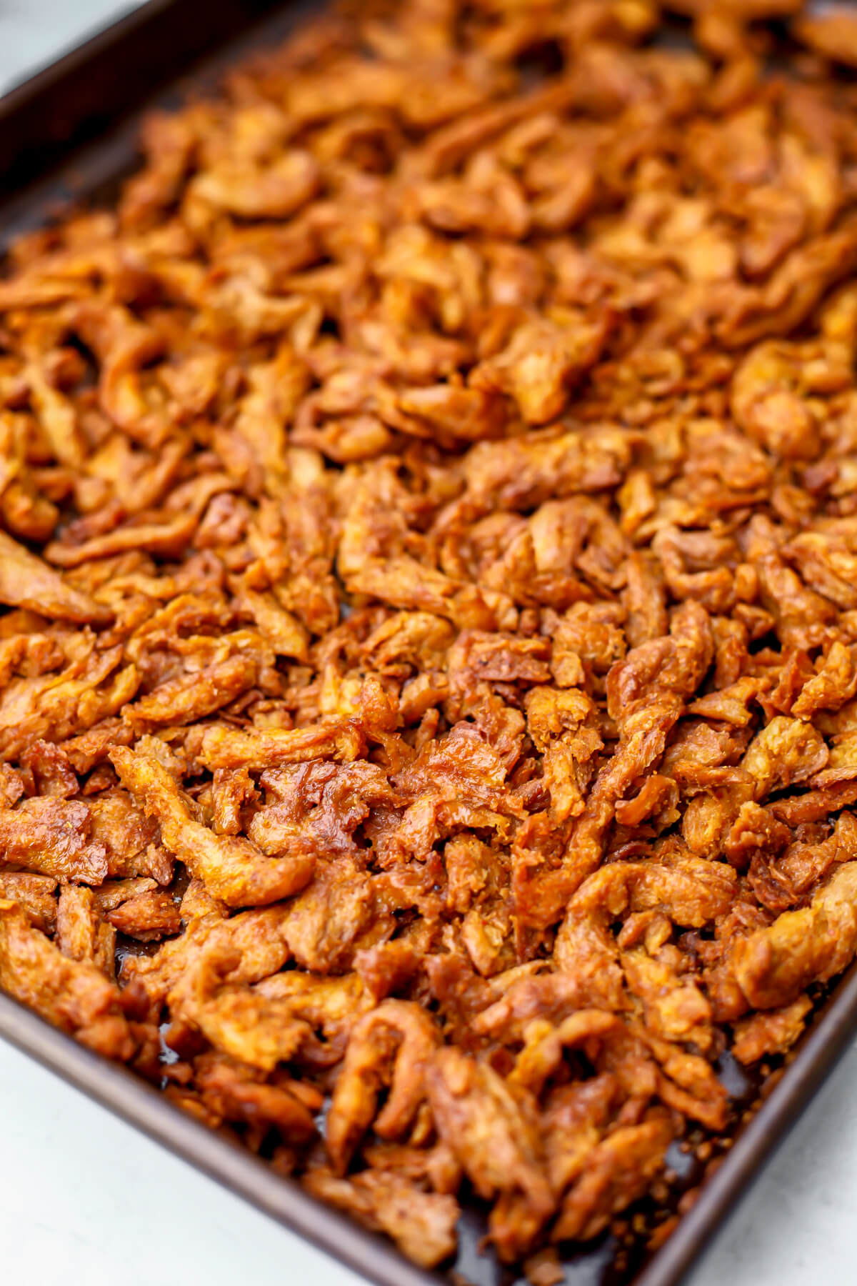A close up of vegan jerky on a baking sheet.