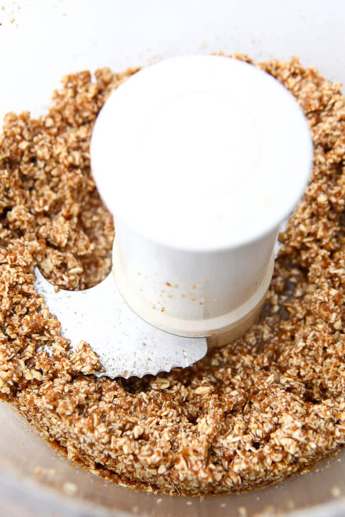 Oats, coconut sugar, and coconut oil blended in a food processor to make a vegan graham cracker crust.