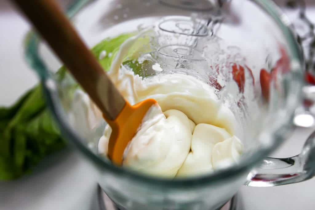 Freshly blended creamy vegan mayo in a blender.