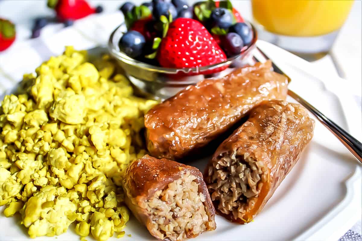 Vegan breakfast sausage with tofu eggs and fruit.