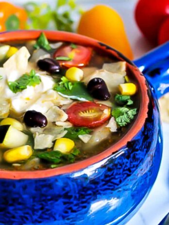 A bowl of gluten free vegan taco soup with vegan sour cream.