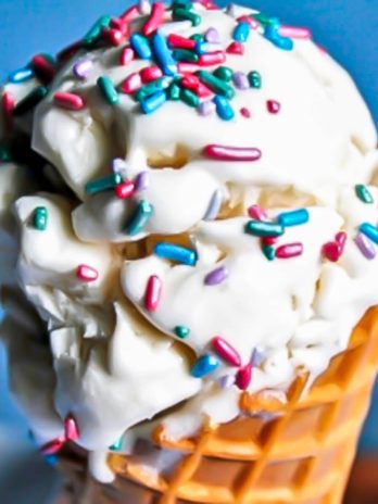 A vanilla aquafaba ice cream cone with sprinkles.