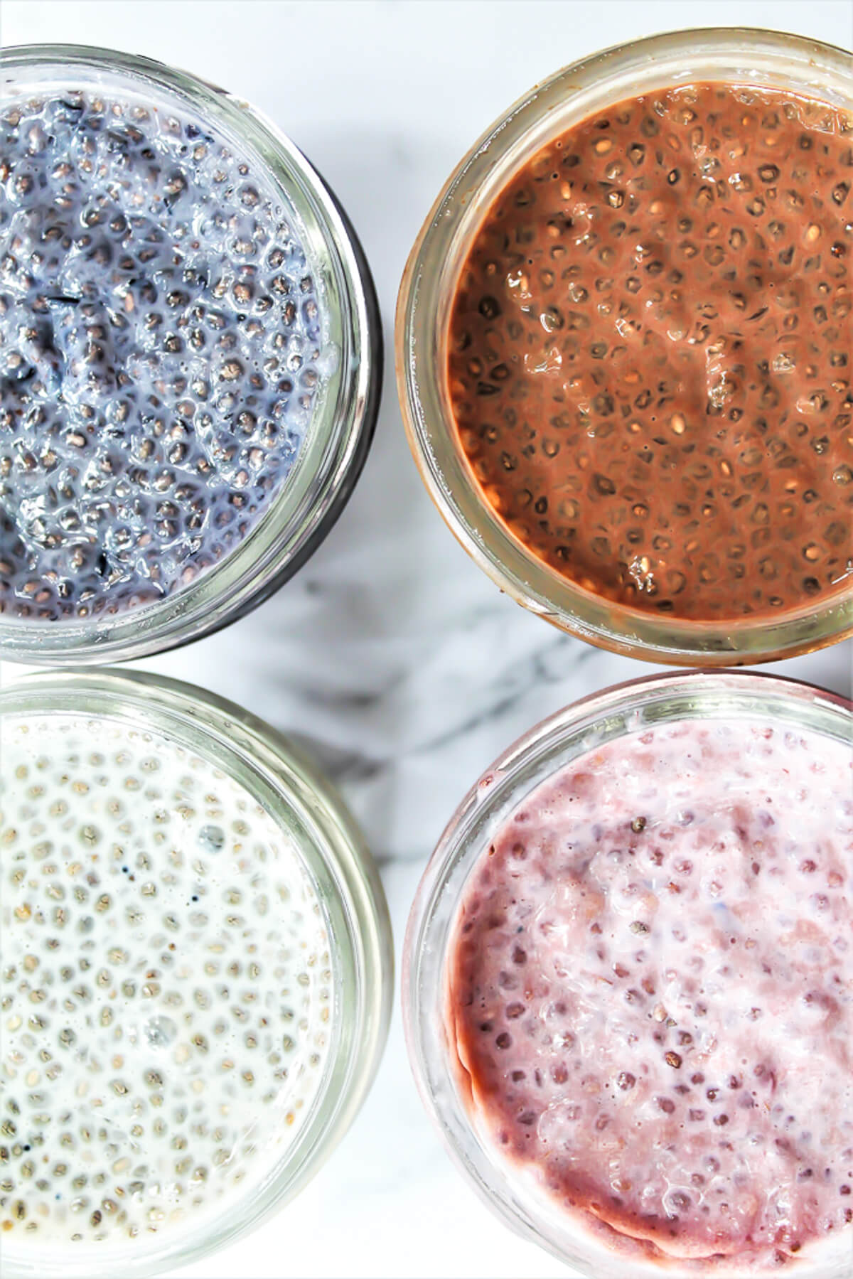 For flavors of chia pudding, blueberry, chocolate, vanilla, and strawberry, in small mason jars.