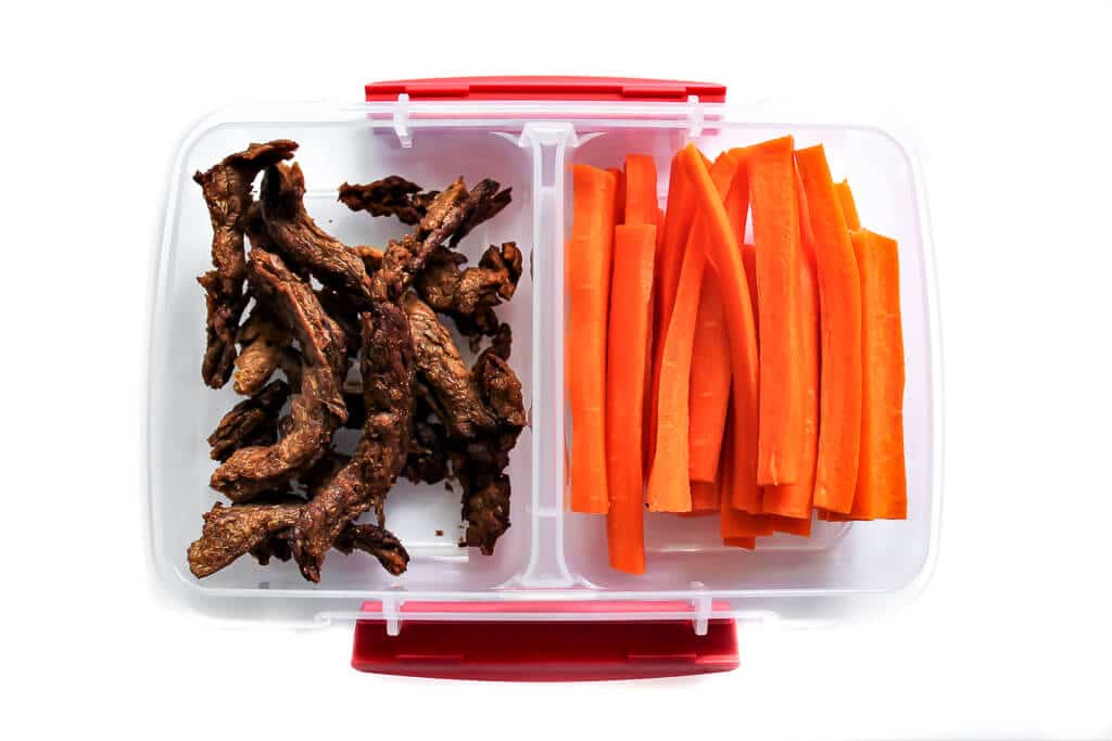 Vegan jerky and carrot sticks for a vegan kids lunch.