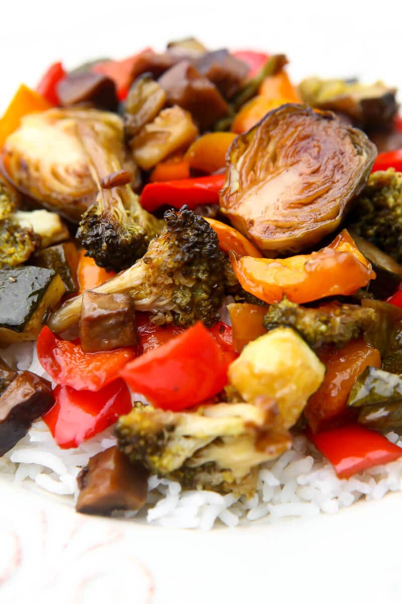 A heaping serving of balsamic roasted vegetables served over white rice.