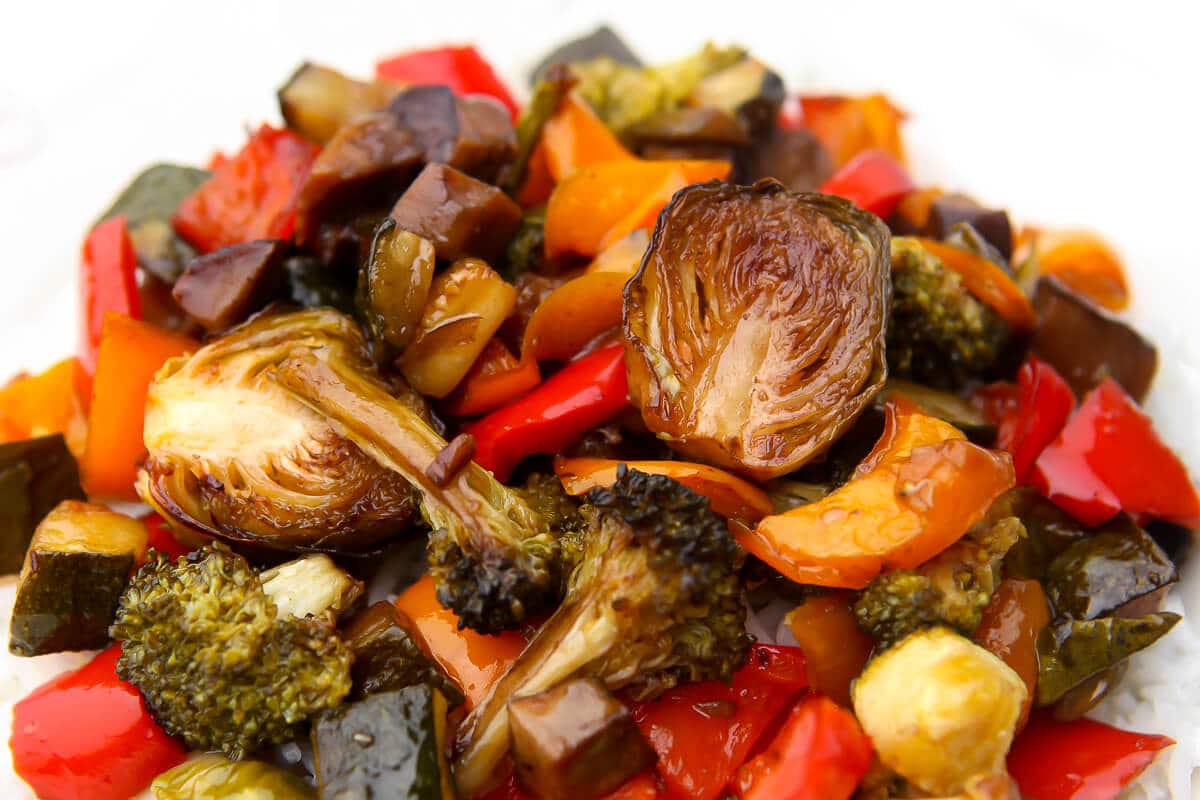 A close up of vegan balsamic roasted veggies served over rice.