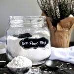 A glass canister filled with gluten-free flour mix.