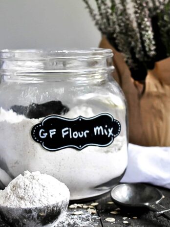A glass canister filled with gluten-free flour mix.