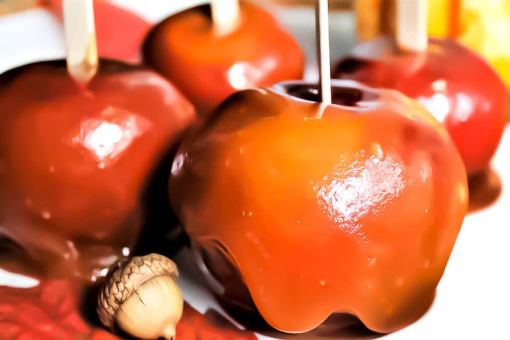 A close up of 4 vegan caramel apples.