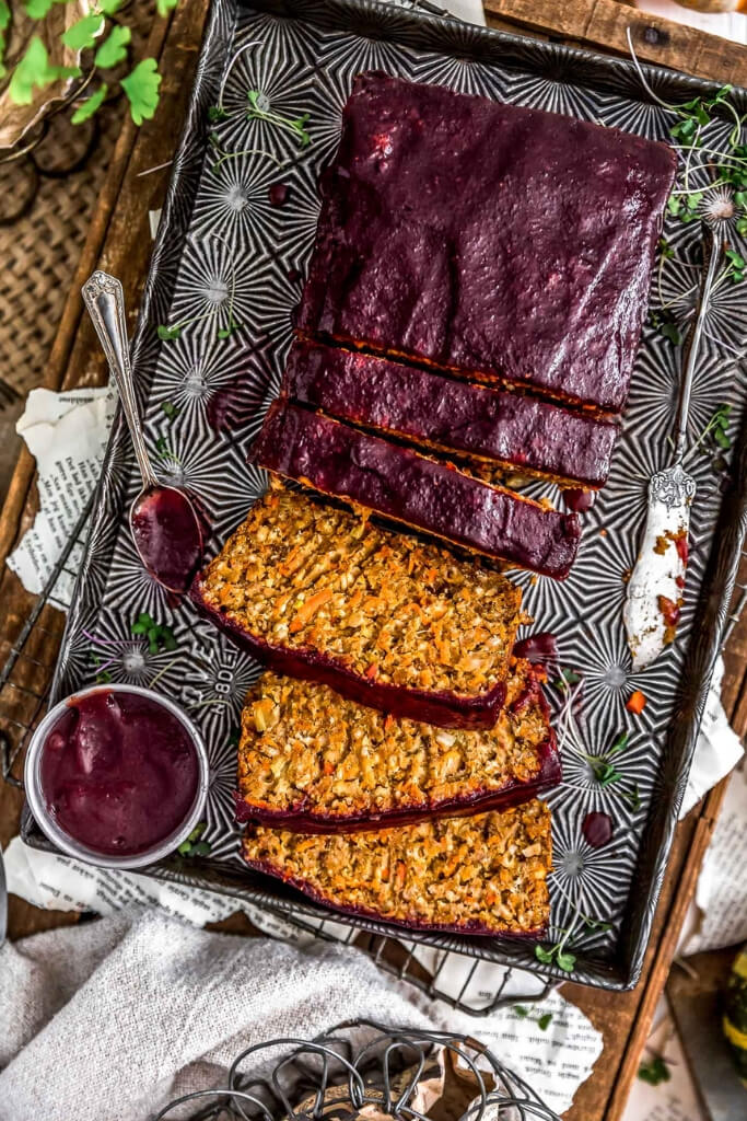 A Harvest Veggie Loaf sliced on a platter for a gluten free vegan Thanksgiving main dish.