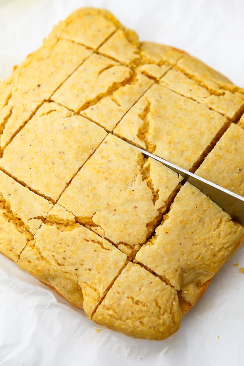 Cutting the vegan cornbread into squares.