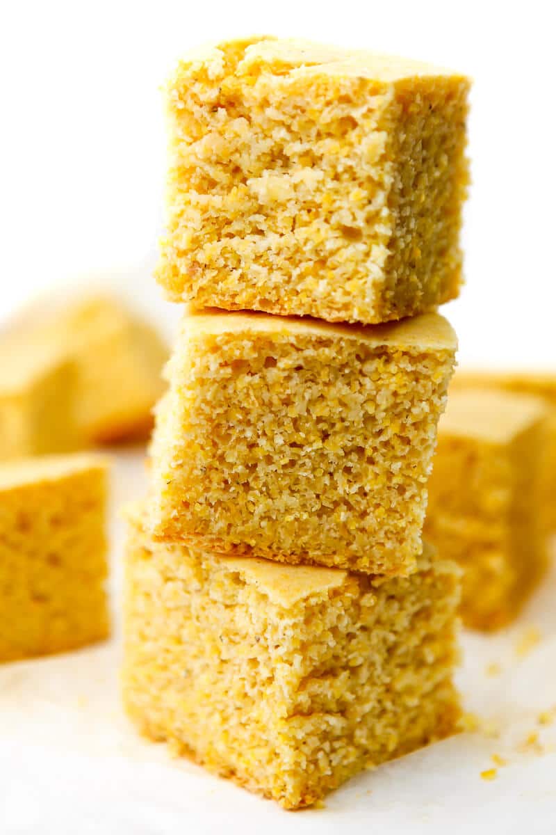 A stack of three pieces of vegan cornbread stacked on top of eachother.
