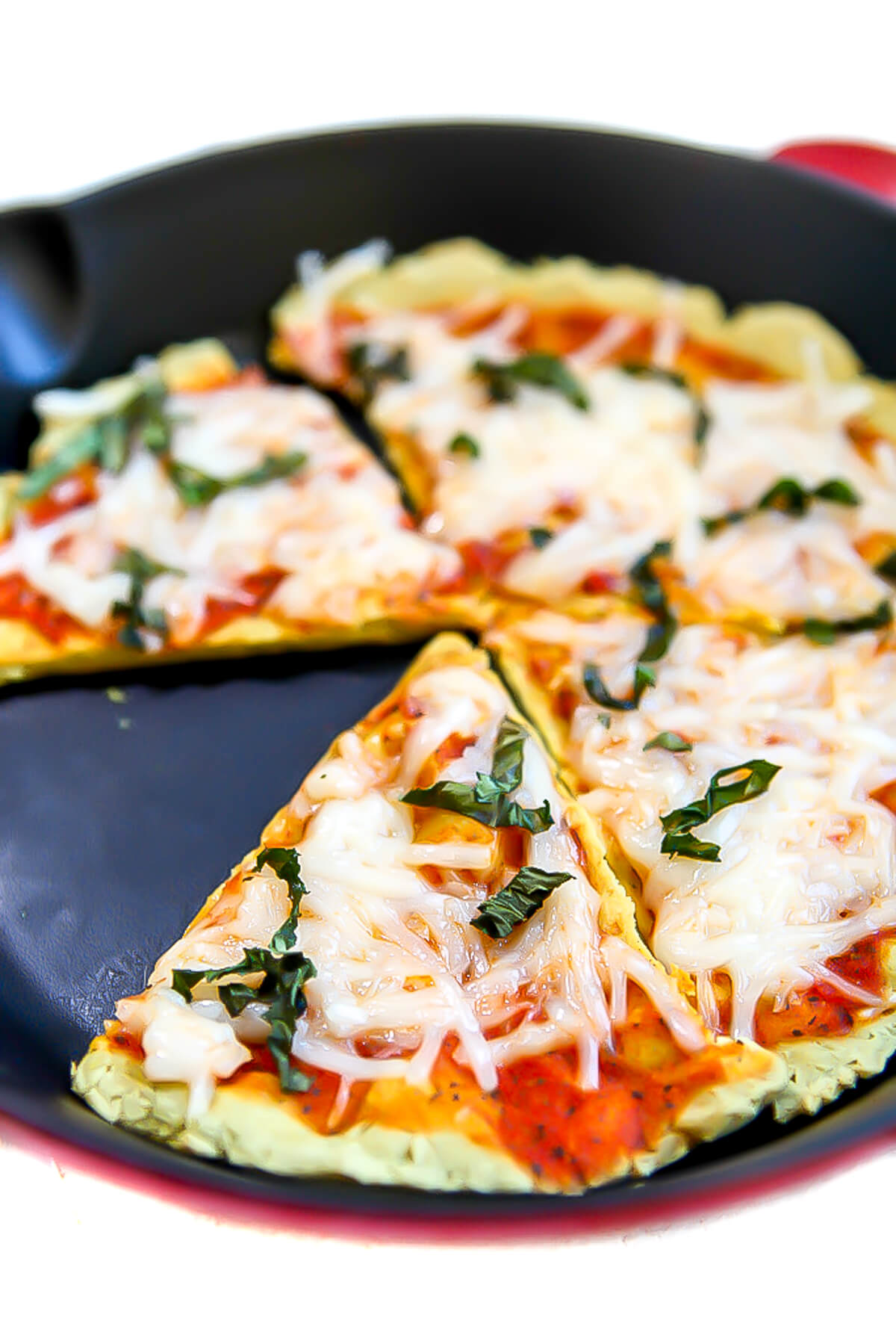 A low carb pizza crust made with tofu in a red iron skillet.