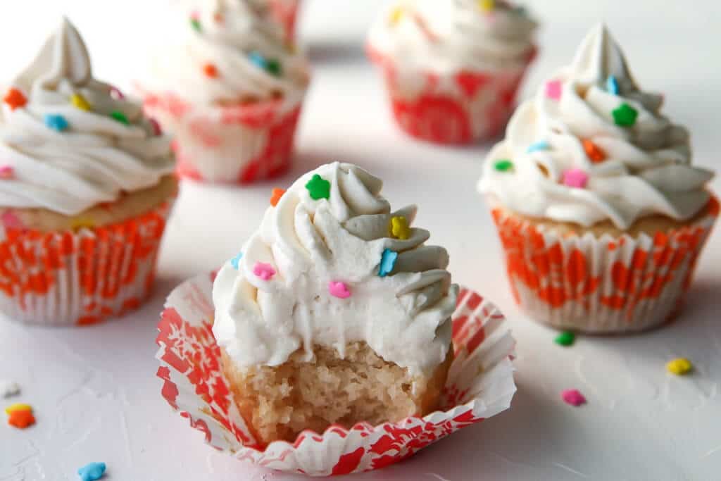 A tray of easy vegan vanilla cupcakes made with the soda cake method.