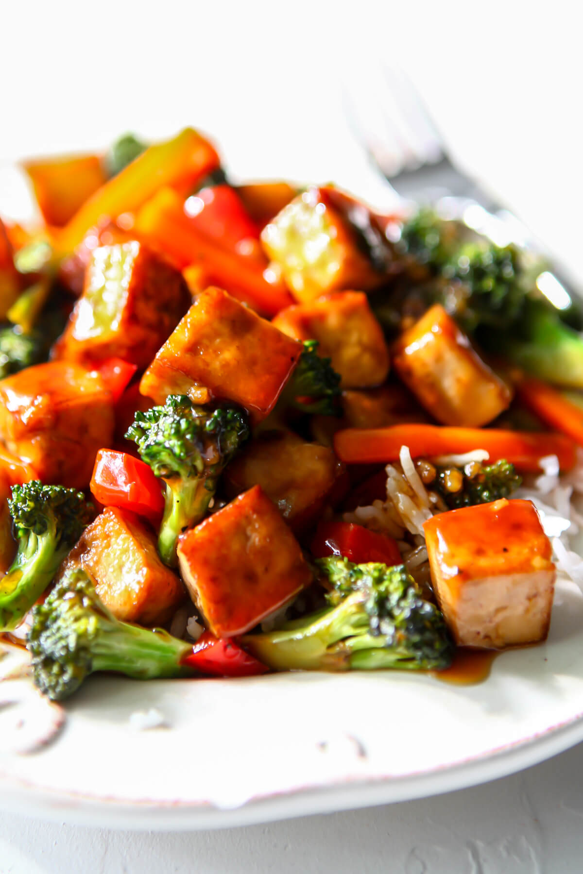 Teriyaki tofu with stir-fried veggies served over rice.