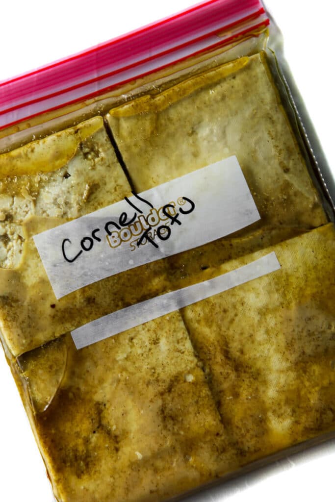A zip lock bag filled with tofu in a Cornell "chicken" style tofu marinade.