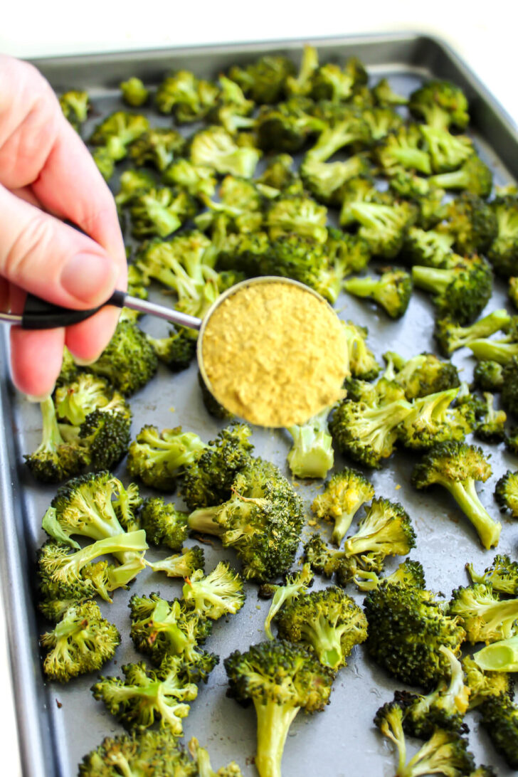 Sprinkling partially baked broccoli with nutritional yeast.