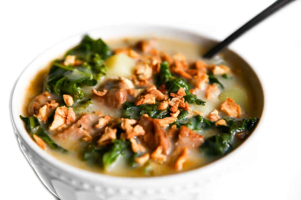Vegan zuppa toscana soup in a white bowl.