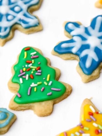Cut out cookies in the shape of stars, Christmas trees, and snowflakes decorated with vegan royal icing.