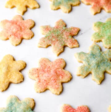 Vegan cut out shortbread cookies with colored sugar on top.