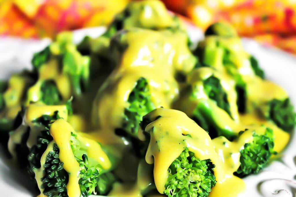 Steamed broccoli with vegan nacho cheese sauce poured over top.