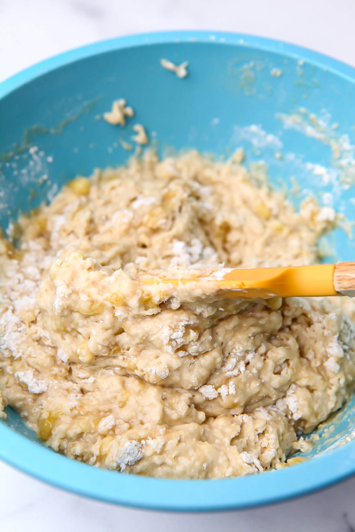 The wet and dry ingredients for banana bread mixed together.