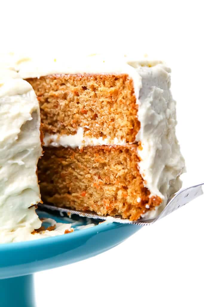 A slice of carrot cake being served.