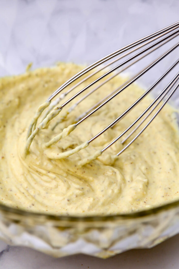The dressing for a vegan potato salad mixing in a bowl.