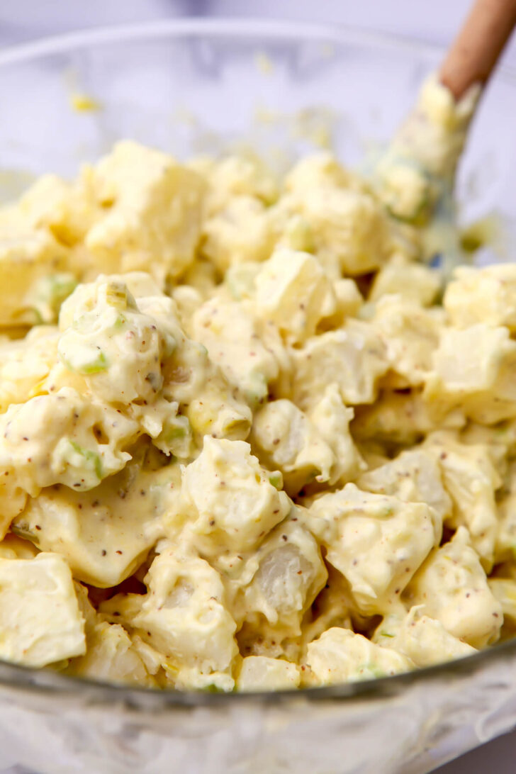 Cooked potato cubes mixed with vegan potato salad dressing.