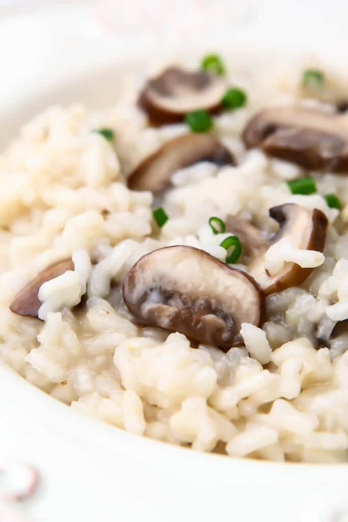 A white plate full of vegan mushroom risotto.