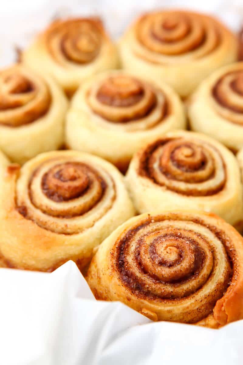 Vegan cinnamon buns baked to a golden brown in a pie dish.