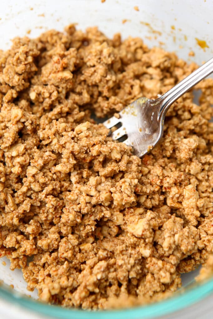 Crumbled tofu soaking in a bacon flavored marinade to make tofu rice paper bacon.