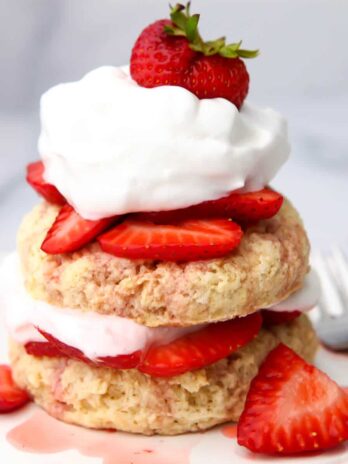 Two layers of vegan shortcake layered with strawberries and vegan whipped cream.
