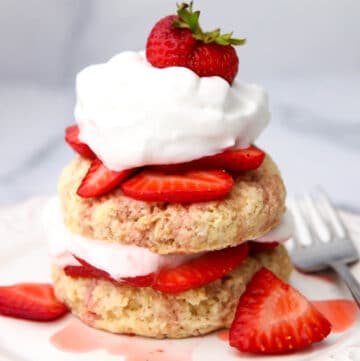 Two layers of vegan shortcake layered with strawberries and vegan whipped cream.