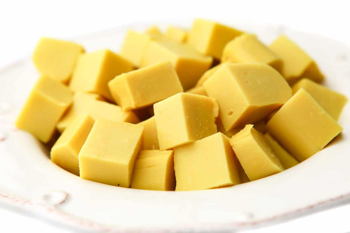 A white bowl filled with cubes of Burmese tofu.