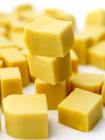 Squares of chickpea tofu on a white surface.