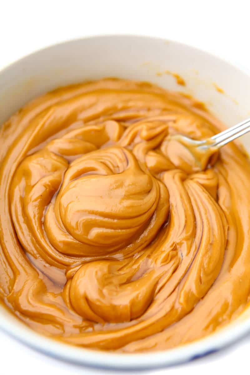 Stirring a bowl of peanut butter and agave nectar to make peanut butter caramel.