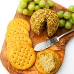 Almond cheese formed into a cheese ball and rolled in crushed pistachio nuts with crackers on the side.