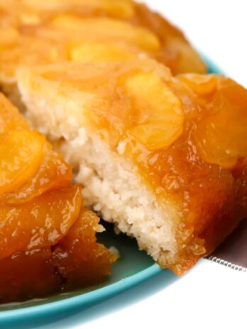 A slice being taken out of a vegan apple cake.