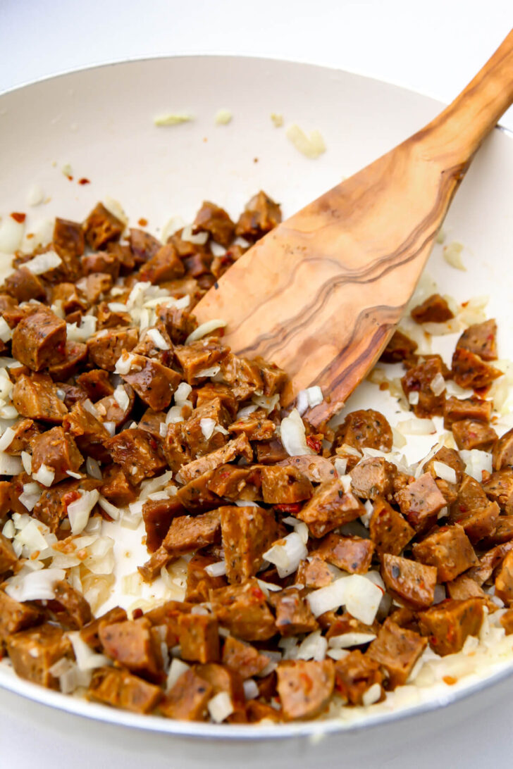 Sauteed onions and vegan sausage to make baked ziti.