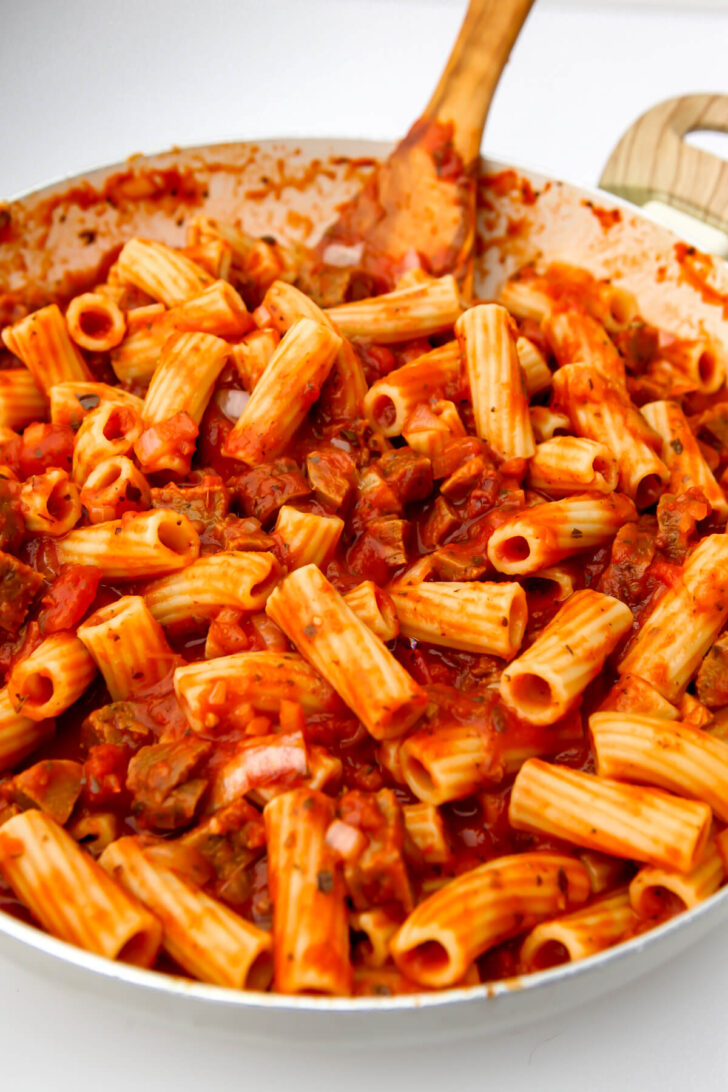 Vegan pasta sauce with vegan sausage with ziti noodles added.