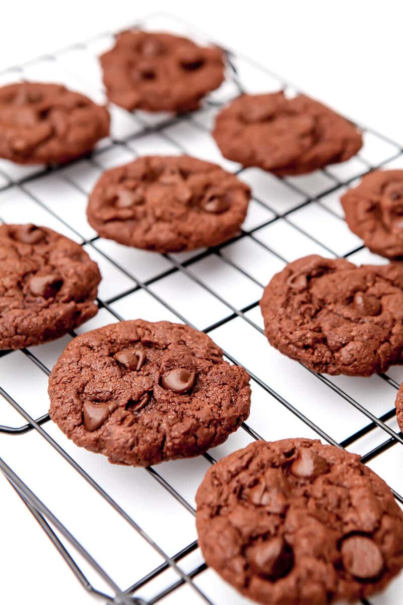 Fudgy vegan chocolate brownie cookies cooling on a cookie rack.